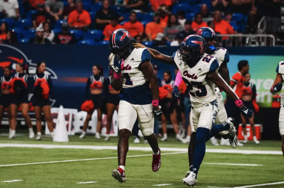 Running back Gemari Sands patting safety CJ Heard on the back in Oct. 19 game against the University of Texas at San Antonio. 